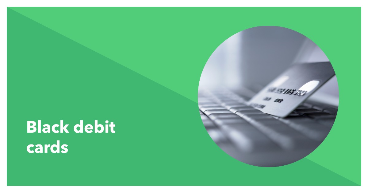 a debit card sitting on the keyboard of a laptop